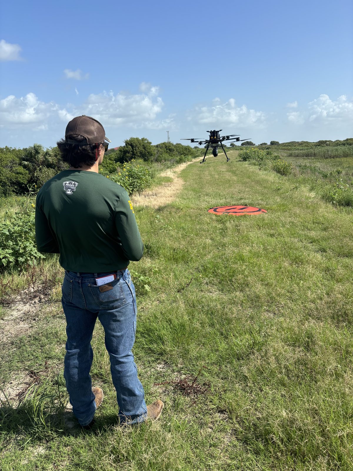 Drone prepared for takeoff in a field setting.